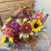 Bouquet of sunflowers, roses, and chrysanthemums with a ribbon accent