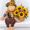 Scarecrow figure beside a basket of sunflowers
