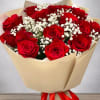 Bouquet of red roses with white baby's breath in beige wrapping