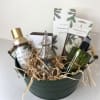 Holiday gift basket with pine-scented bath products and a small decorative tree