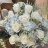 White roses and pale blue hydrangeas in a bouquet