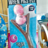 Packaged pig-themed toy slingshot with two pink pig balls