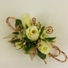 White rose corsage with gold ribbon and decorative loops