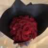 Bouquet of red roses wrapped in black paper
