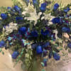 Large bouquet of blue roses and white lilies with mixed greenery