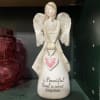 Decorative angel figurine with a pink heart and memorial text