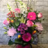 Bright blooms in blue, pink, lavender and yellow. This tall glass cylinder
