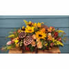 Autumn floral arrangement with sunflowers, peach roses, and lotus pods