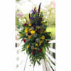 Tall standing floral spray with sunflowers, red carnations, and purple irises