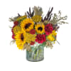 Sunflowers and red carnations in a glass vase