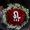 Red roses arranged with white baby's breath in black wrapping
