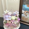 Pastel bouquet with white and lavender flowers in a white tray