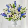 We arrange soft blue and white blooms into a calming urn arrangement.