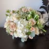Bouquet of pale roses and white hydrangeas with green accents