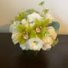 White and green floral arrangement in a glass vase