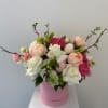 Pink and white rose arrangement in a pink hat box