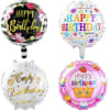 Four round birthday balloons with colorful printed messages
