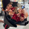Bouquet of red and blush roses wrapped in black paper
