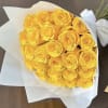Bouquet of yellow roses wrapped in white paper