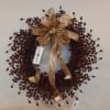 Decorative berry wreath with a gold glitter bow