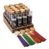 Assorted scented candles in glass jars with colored incense sticks