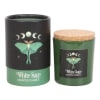 Two white sage scented candles in green jars with black labels and cork lids