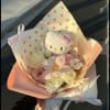 Hello Kitty plush in a pastel bouquet with pink and white flowers