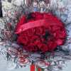 Red rose bouquet with a horror-themed heart topper and ribbon