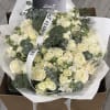 Bouquet of cream roses with eucalyptus in white wrap