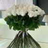 Bouquet of pale pink roses with long stems and ribbon ties