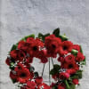 Heart-shaped red flower wreath on a stand