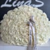 Large dome bouquet of white roses with a printed ribbon bow