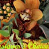Orange orchid and autumn mums with eucalyptus foliage