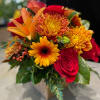 Bouquet of red roses, orange lilies, and yellow chrysanthemums