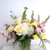 Bouquet of yellow and pink flowers in a glass vase