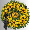 Yellow floral wreath with sunflowers, roses, and a black ribbon