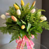 Mixed tulip bouquet in a glass vase with a pink plaid ribbon