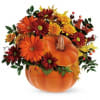 Orange pumpkin arrangement with red and yellow flowers