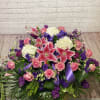 Large bouquet of pink roses, white hydrangeas, and pink lilies with purple ribbon