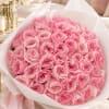 Bouquet of pink roses wrapped in white paper