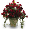 Red and white roses arranged in a decorative vase