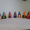 Seven small painted gnome figurines lined up on a tabletop