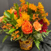 Orange roses and yellow daisies in a sunflower-patterned vase