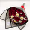 Bouquet of red roses with gold accents wrapped in black paper