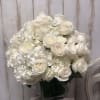 White roses and hydrangeas arranged in a square glass vase