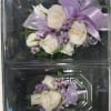 White rose corsages with lavender ribbon and small purple filler flowers
