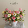 Pink and white mixed flower arrangement in a white vase