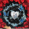 Black rose bouquet with blue baby's breath and butterfly accents