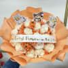 White rose bouquet with orange accents and Halloween character picks