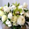 White and pale green bouquet with roses, orchids, and mums